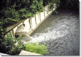 Water flowing over concrete weir